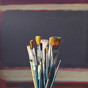 Paintbrushes in front of a canvas